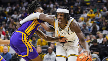 Jan 7, 2025; Columbia, Missouri, USA; Missouri Tigers guard Mark Mitchell (25) drives against LSU Tigers forward Daimion Collins (10) during the first half
 at Mizzou Arena. Mandatory Credit: Jay Biggerstaff-Imagn Images