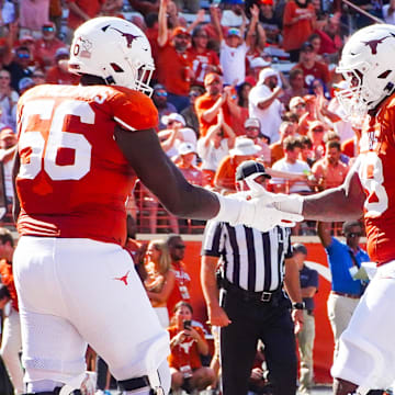 Aug 31, 2024; Austin, Texas, USA; Texas Longhorns lineman Cam WIlliams (56) and Kelvin Banks (78) celebrate in the end zone following a touchdown during the seond half of a game at Darrell K Royal-Texas Memorial Stadium. Mandatory Credit: Aaron Meullion-Imagn Images