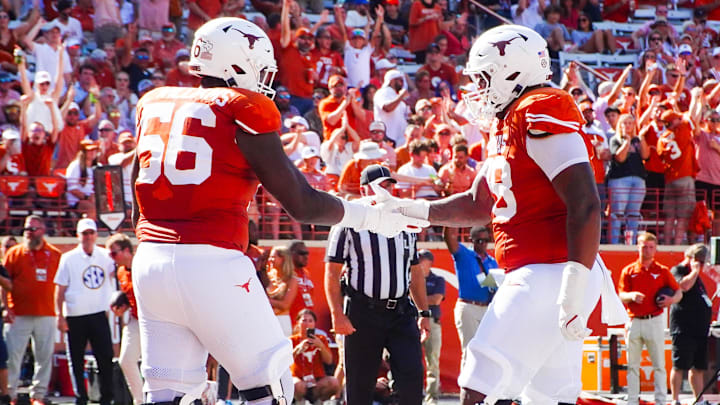 Aug 31, 2024; Austin, Texas, USA; Texas Longhorns lineman Cam WIlliams (56) and Kelvin Banks (78) celebrate in the end zone following a touchdown during the seond half of a game at Darrell K Royal-Texas Memorial Stadium. Mandatory Credit: Aaron Meullion-Imagn Images