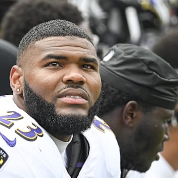 Baltimore Ravens linebacker Trenton Simpson (23) sits on the bench with teammates during the game against the Atlanta Falcons at M&T Bank Stadium. 