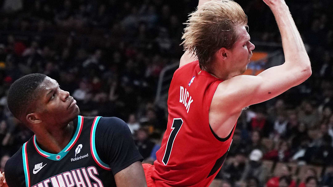 Nov 2, 2025; Toronto, Ontario, CAN; Toronto Raptors guard Gradey Dick (1) drives to the basket over Memphis Grizzlies forward Cedric Coward (23) during the fourth quarter at Scotiabank Arena. Mandatory Credit: Nick Turchiaro-Imagn Images