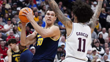Mar 22, 2025; Denver, CO, USA; Michigan Wolverines center Vladislav Goldin (50) looks to shoot the ball over Texas A&M Aggies forward Andersson Garcia (11) during the second half in the second round of the NCAA Tournament  at Ball Arena. Mandatory Credit: Ron Chenoy-Imagn Images
