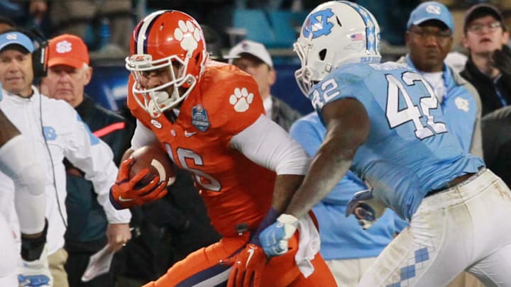 Clemson tight end Jordan Leggett (16) runs by North Carolina's Shakeel Rashad during the second quarter of the ACC Championship game in Charlotte, North Carolina.