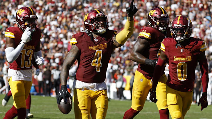 Oct 6, 2024; Landover, Maryland, USA; Washington Commanders linebacker Frankie Luvu (4) celebrates with teammates after recovering a fumble against the Cleveland Browns during the third quarter at NorthWest Stadium. Mandatory Credit: Geoff Burke-Imagn Images