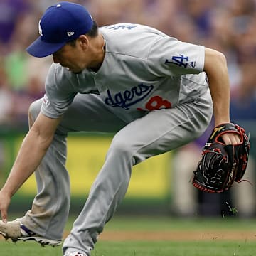 Jun 30, 2019; Denver, CO, USA; Los Angeles Dodgers starting pitcher Kenta Maeda (18) fields the ball in the third inning against the Colorado Rockies at Coors Field. Mandatory Credit: Isaiah J. Downing-Imagn Images