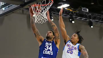 Dec 22, 2021; Las Vegas, NV, USA; Delaware Blue Coats guard Jarron Cumberland (34) shoots inside the defense of Oklahoma City Blue guard Rob Edwards (25) during the fourth quarter at Mandalay Bay Convention Center. Mandatory Credit: Stephen R. Sylvanie-Imagn Images