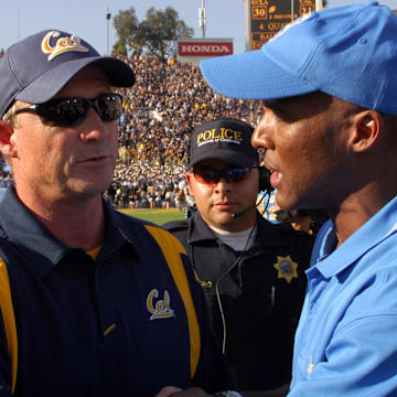 Jeff Tedford, left, greets UCLA coach Karl Dorrell