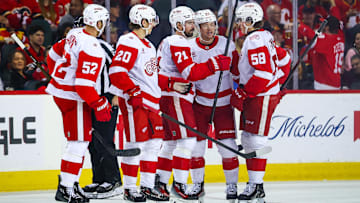 Dec 10, 2025; Calgary, Alberta, CAN;Detroit Red Wings center Dylan Larkin (71) celebrates his goal with teammates against the Calgary Flames  during the second period at Scotiabank Saddledome. Mandatory Credit: Sergei Belski-Imagn Images