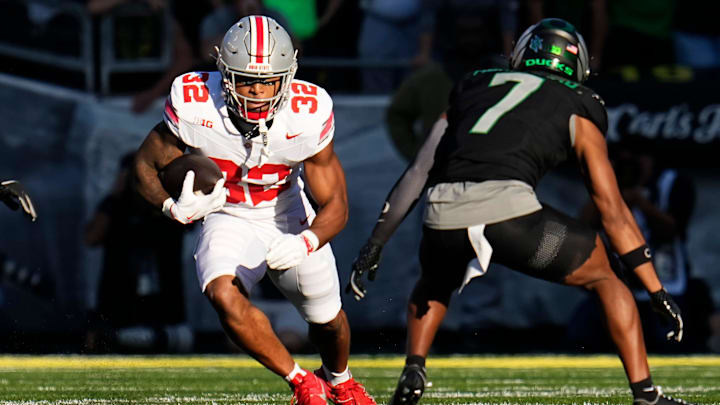 Oct 12, 2024; Eugene, Oregon, USA; Ohio State Buckeyes running back TreVeyon Henderson (32) runs at Oregon Ducks defensive back Jabbar Muhammad (7) during the first half of the NCAA football game at Autzen Stadium Oct 12, 2024; Eugene, Oregon, USA; Ohio State Buckeyes running back TreVeyon Henderson (32) runs at Oregon Ducks defensive back Jabbar Muhammad (7) during the first half of the NCAA football game at Autzen Stadium