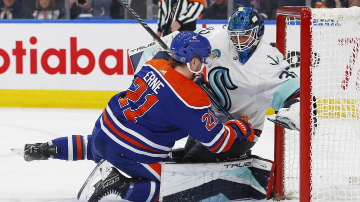 Nov 15, 2023; Edmonton, Alberta, CAN; Edmonton Oilers forward Adam Erne (21) falls into Seattle Kraken Goalie