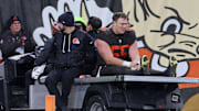 Dec 7, 2025; Cleveland, Ohio, USA; Cleveland Browns center Ethan Pocic (55) leaves the field on a cart after suffering an apparent injury against the Tennessee Titans during the fourth quarter at Huntington Bank Field. Mandatory Credit: Scott Galvin-Imagn Images