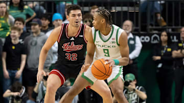 Oregon guard Keeshawn Barthelemy looks for room to move under cover from Indiana guard Trey Galloway last week.