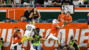 Nov 11, 2017; Miami Gardens, FL, USA; Miami Hurricanes wide receiver Braxton Berrios (8) catches a pass for a touchdown in front of Notre Dame Fighting Irish cornerback Shaun Crawford (20) in the first quarter at Hard Rock Stadium. Mandatory Credit: Matt Cashore-Imagn Images