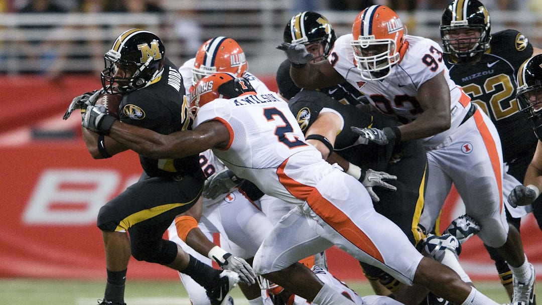 September 4, 2010; St. Louis, MO, USA; Missouri Tigers running back De'Vion Moore (26) runs the ball as Illinois Fighting Illini linebacker Martez Wilson (2) defends during the first half at the Edward Jones Dome. Mandatory Credit: Jeff Curry-Imagn Images