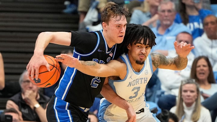 Mar 8, 2025; Chapel Hill, North Carolina, USA;  Duke Blue Devils forward Cooper Flagg (2) with the ball as North Carolina Tar Heels guard Elliot Cadeau (3) defends in the second half.
