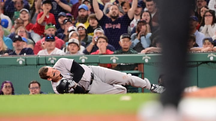 Jun 16, 2024; Boston, Massachusetts, USA; New York Yankees first baseman Anthony Rizzo (48) trips on Boston Red Sox pitcher Brennan Bernardino (not pictured) and rolls on the ground during the seventh inning at Fenway Park. 