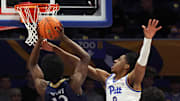 Nov 23, 2025; Pittsburgh, Pennsylvania, USA;  Pittsburgh Panthers guard Omari Witherspoon (8) fouls Quinnipiac Bobcats forward Spence Wewe (12) during the first half against at the Petersen Events Center. Mandatory Credit: Charles LeClaire-Imagn Images