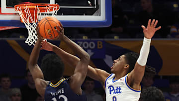 Nov 23, 2025; Pittsburgh, Pennsylvania, USA;  Pittsburgh Panthers guard Omari Witherspoon (8) fouls Quinnipiac Bobcats forward Spence Wewe (12) during the first half against at the Petersen Events Center. Mandatory Credit: Charles LeClaire-Imagn Images