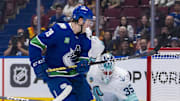 Sep 24, 2024; Vancouver, British Columbia, CAN; Seattle Kraken defenseman Jamie Oleksiak (24) and goalie Joey Daccord (35) watch the shot from Vancouver Canucks forward Sammy Blais (79) hit the post during the first period at Rogers Arena. Mandatory Credit: Bob Frid-Imagn Images