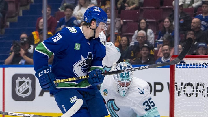 Sep 24, 2024; Vancouver, British Columbia, CAN; Seattle Kraken defenseman Jamie Oleksiak (24) and goalie Joey Daccord (35) watch the shot from Vancouver Canucks forward Sammy Blais (79) hit the post during the first period at Rogers Arena. Mandatory Credit: Bob Frid-Imagn Images