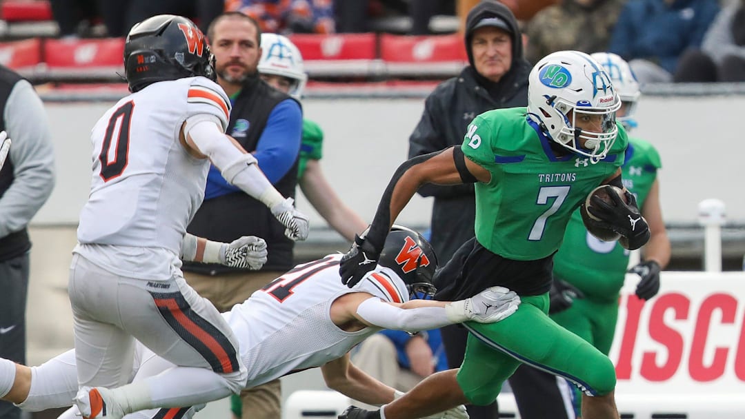 Green Bay Notre Dame's Kingston Allen (7) is forced out of bounds by West De Pere High School's Cooper Borowicz (21) during the WIAA Division 2 state championship football game on Friday, November 21, 2025, at Camp Randall Stadium in Madison, Wis. 
Tork Mason/USA TODAY NETWORK-Wisconsin
