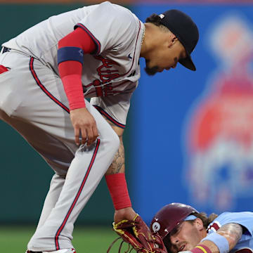 Aug 29, 2024; Philadelphia, Pennsylvania, USA; Philadelphia Phillies second base Bryson Stott (5) seals second base past Atlanta Braves shortstop Orlando Arcia (11) during the second inning at Citizens Bank Park.