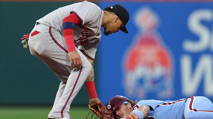 Aug 29, 2024; Philadelphia, Pennsylvania, USA; Philadelphia Phillies second base Bryson Stott (5) seals second base past Atlanta Braves shortstop Orlando Arcia (11) during the second inning at Citizens Bank Park.