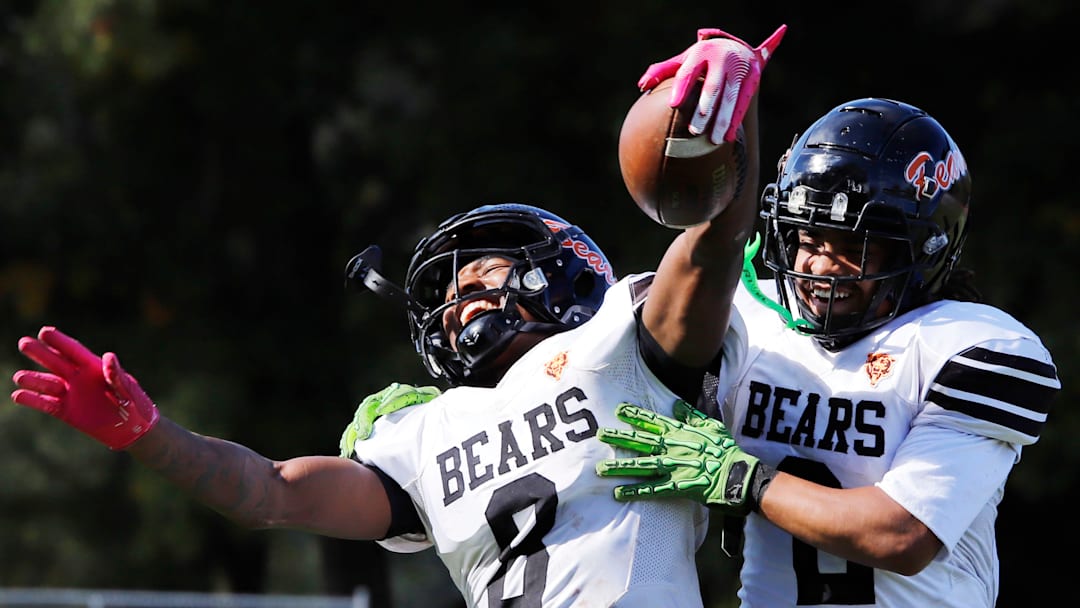 Clairton's Brandon Murphy, left, celebrates with Donte Wright after catching a  37-yard touchdown pass from Jeffrey Thompson Saturday at Riverside Park Oct. 12 in Oakmont. The Bears advance to the PIAA Class A final for the eighth time and will have their third matchup with District 6 champion Bishop Guilfoyle in the final.