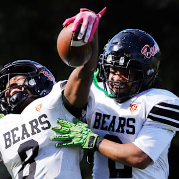 Clairton's Brandon Murphy, left, celebrates with Donte Wright after catching a  37-yard touchdown pass from Jeffrey Thompson Saturday at Riverside Park Oct. 12 in Oakmont. The Bears advance to the PIAA Class A final for the eighth time and will have their third matchup with District 6 champion Bishop Guilfoyle in the final.