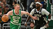 Apr 9, 2024; Milwaukee, Wisconsin, USA; Boston Celtics forward Sam Hauser (30) drives past Milwaukee Bucks forward Bobby Portis (9) in the fourth quarter at Fiserv Forum. Mandatory Credit: Benny Sieu-Imagn Images