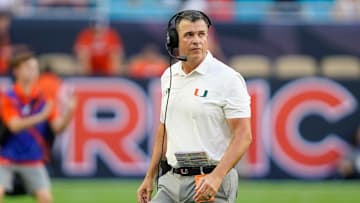 Nov 8, 2025; Miami Gardens, Florida, USA; Miami Hurricanes head coach Mario Cristobal looks at the scoreboard in a game against the Syracuse Orange during the second quarter at Hard Rock Stadium. Mandatory Credit: Jeff Romance-Imagn Images