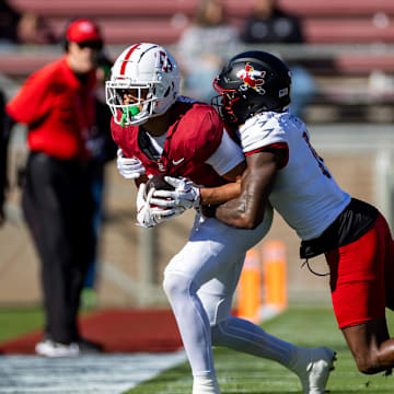 Nov 16, 2024; Stanford, California, USA; Stanford Cardinal wide receiver Emmett Mosley V (10) is tackled out of bounds during the first quarter against the Louisville Cardinals at Stanford Stadium. Mandatory Credit: Bob Kupbens-Imagn Images