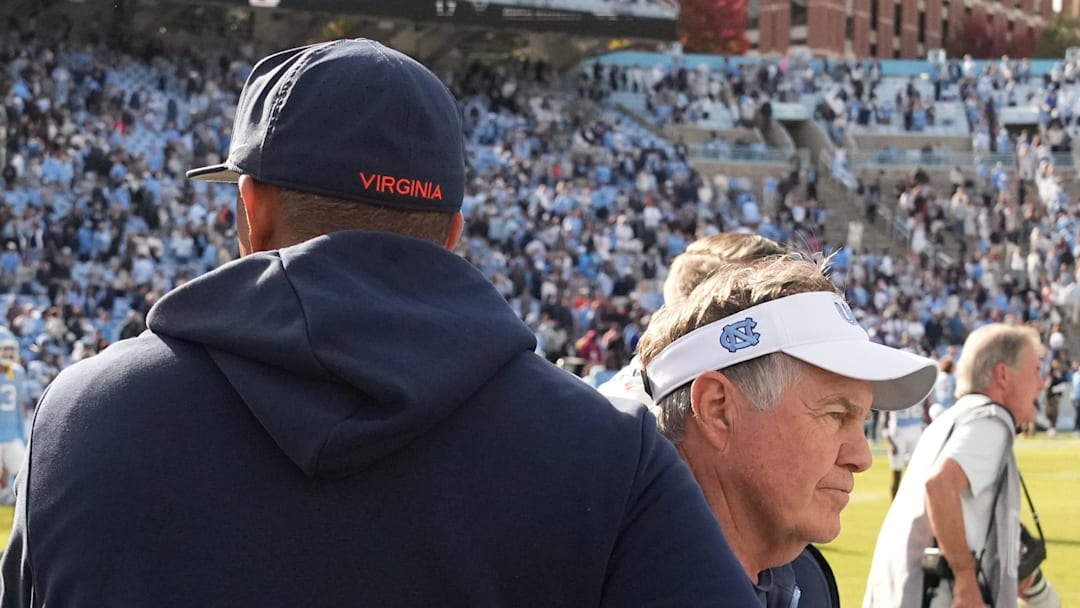 Oct 25, 2025; Chapel Hill, North Carolina, USA; North Carolina Tar Heels head coach Bill Belichick shakes Virginia Cavaliers head coach Tony Elliott hand after the Tar Heels lose to Virginia in overtime at Kenan Stadium. Mandatory Credit: Bob Donnan-Imagn Images