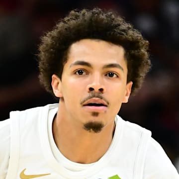 Cleveland Cavaliers guard Craig Porter Jr. brings the ball up court against Atlanta Hawks guard Nickeil Alexander-Walker.