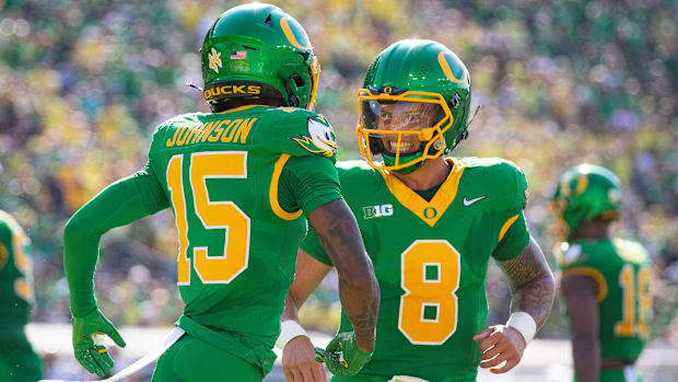 Oregon Ducks quarterback Dillon Gabriel and Oregon Ducks wide receiver Tez Johnson celebrate a touchdown by Johnson as the Or