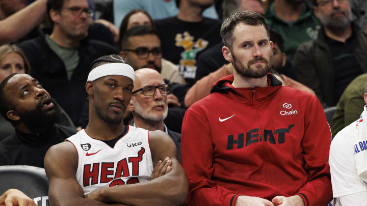 Apr 19, 2023; Milwaukee, Wisconsin, USA; Miami Heat forward Jimmy Butler (22), forward Kevin Love (42) and guard Gabe Vincent (2) look on from the bench during the fourth quarter against the Milwaukee Bucks during game two of the 2023 NBA Playoffs at Fiserv Forum. Mandatory Credit: Jeff Hanisch-USA TODAY Sports