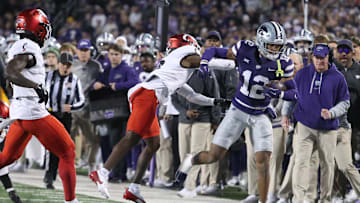 Nov 23, 2024; Manhattan, Kansas, USA; Kansas State Wildcats wide receiver Tre Spivey (12) is pushed out of bounds by Cincinnati Bearcats cornerback Ormanie Arnold (8) during the first quarter at Bill Snyder Family Football Stadium. Mandatory Credit: Scott Sewell-Imagn Images