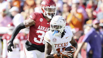 Nov 16, 2024; Fayetteville, Arkansas, USA; Texas Longhorns wide receiver Silas Bolden (11) runs the ball in the first quarter as Arkansas Razorbacks linebacker Larry Worth III (30) defends at Donald W. Reynolds Razorback Stadium. Mandatory Credit: Nelson Chenault-Imagn Images