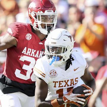 Nov 16, 2024; Fayetteville, Arkansas, USA; Texas Longhorns wide receiver Silas Bolden (11) runs the ball in the first quarter as Arkansas Razorbacks linebacker Larry Worth III (30) defends at Donald W. Reynolds Razorback Stadium. Mandatory Credit: Nelson Chenault-Imagn Images