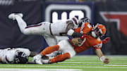 Sep 15, 2024; Houston, Texas, USA; Houston Texans linebacker Azeez Al-Shaair (0) tackles Chicago Bears quarterback Caleb Williams (18) during the fourth quarter at NRG Stadium. Mandatory Credit: Troy Taormina-Imagn Images