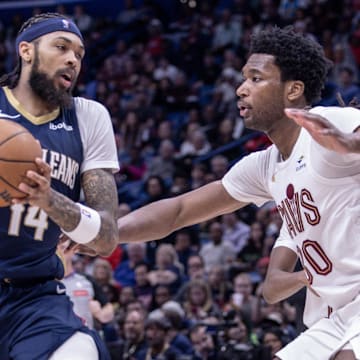 Mar 13, 2024; New Orleans, Louisiana, USA; New Orleans Pelicans forward Brandon Ingram (14) dribbles against Cleveland Cavaliers center Damian Jones (30) during the second half at Smoothie King Center.