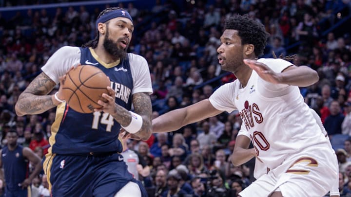 Mar 13, 2024; New Orleans, Louisiana, USA; New Orleans Pelicans forward Brandon Ingram (14) dribbles against Cleveland Cavaliers center Damian Jones (30) during the second half at Smoothie King Center.