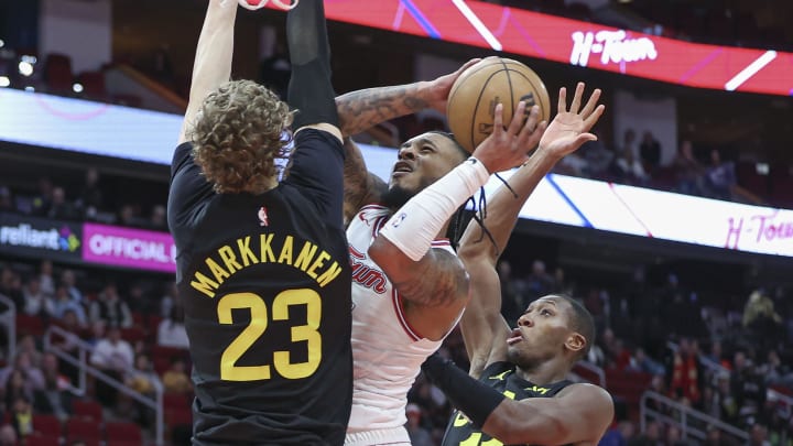 Jan 20, 2024; Houston, Texas, USA; Houston Rockets forward Cam Whitmore (7) attempts to score a basket as Utah Jazz forward Lauri Markkanen (23) and guard Kris Dunn (11) defend during the fourth quarter at Toyota Center. Mandatory Credit: Troy Taormina-USA TODAY Sports