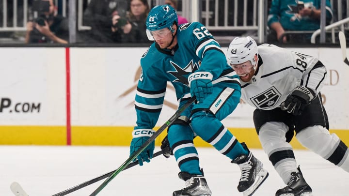 Apr 4, 2024; San Jose, California, USA; Los Angeles Kings defenseman Vladislav Gavrikov (84) extends for the puck against San Jose Sharks right wing Kevin Labanc (62) during the third period at SAP Center at San Jose. Mandatory Credit: Robert Edwards-USA TODAY Sports