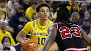 Michigan guard Justin Pippen looks to pass the ball.