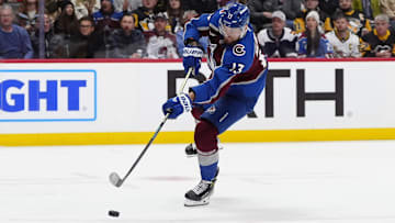 Mar 4, 2025; Denver, Colorado, USA; Colorado Avalanche right wing Valeri Nichushkin (13) shoots the puck in the second period against the Pittsburgh Penguins at Ball Arena. Mandatory Credit: Ron Chenoy-Imagn Images