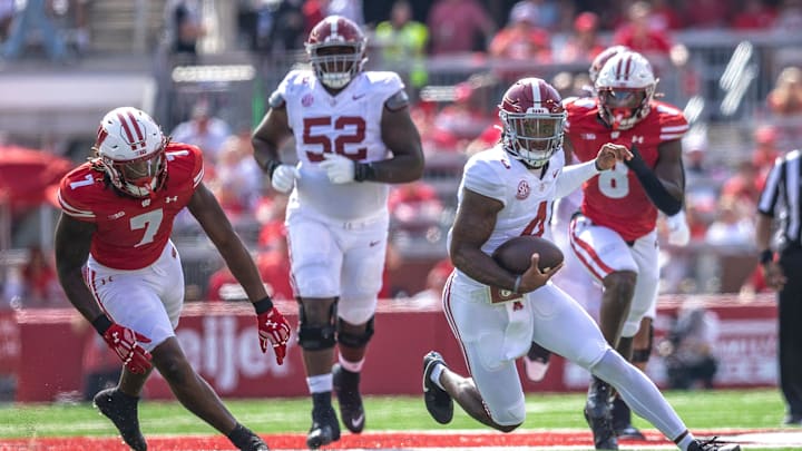 Alabama quarterback Jalen Milroe (4) runs the ball through a defense during the game against Wisconsin at Camp Randall Stadium in Madison, Wis. on Saturday, September 14, 2024.