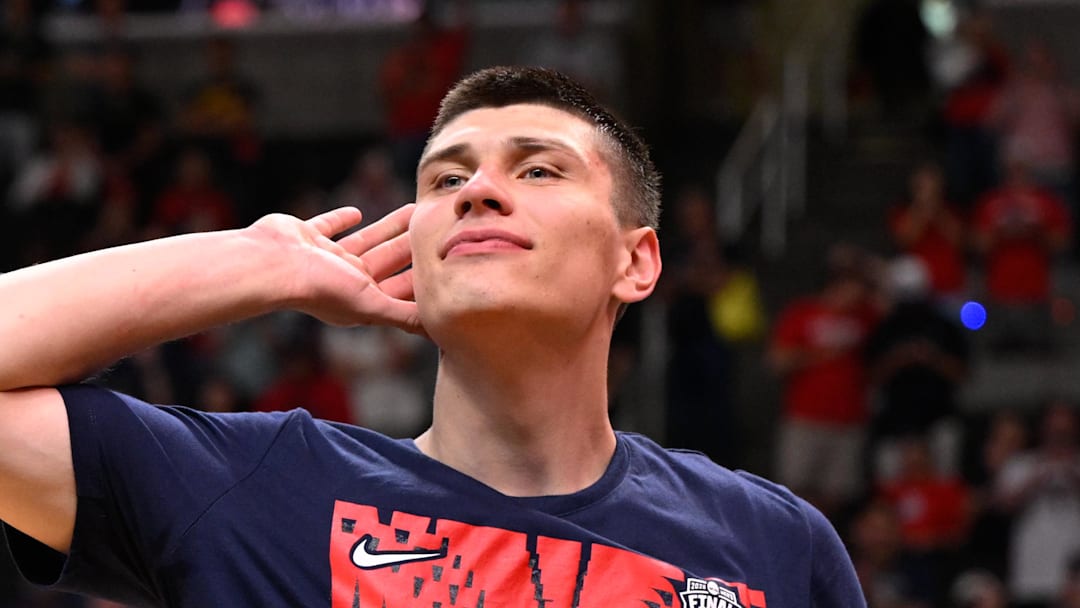 Mar 28, 2026; San Jose, CA, USA; Arizona Wildcats forward Ivan Kharchenkov (8) prepares to cut down the net after an Elite Eight game against the Purdue Boilermakers of the West Regional of the men's 2026 NCAA Tournament at SAP Center. Mandatory Credit: Eakin Howard-Imagn Images