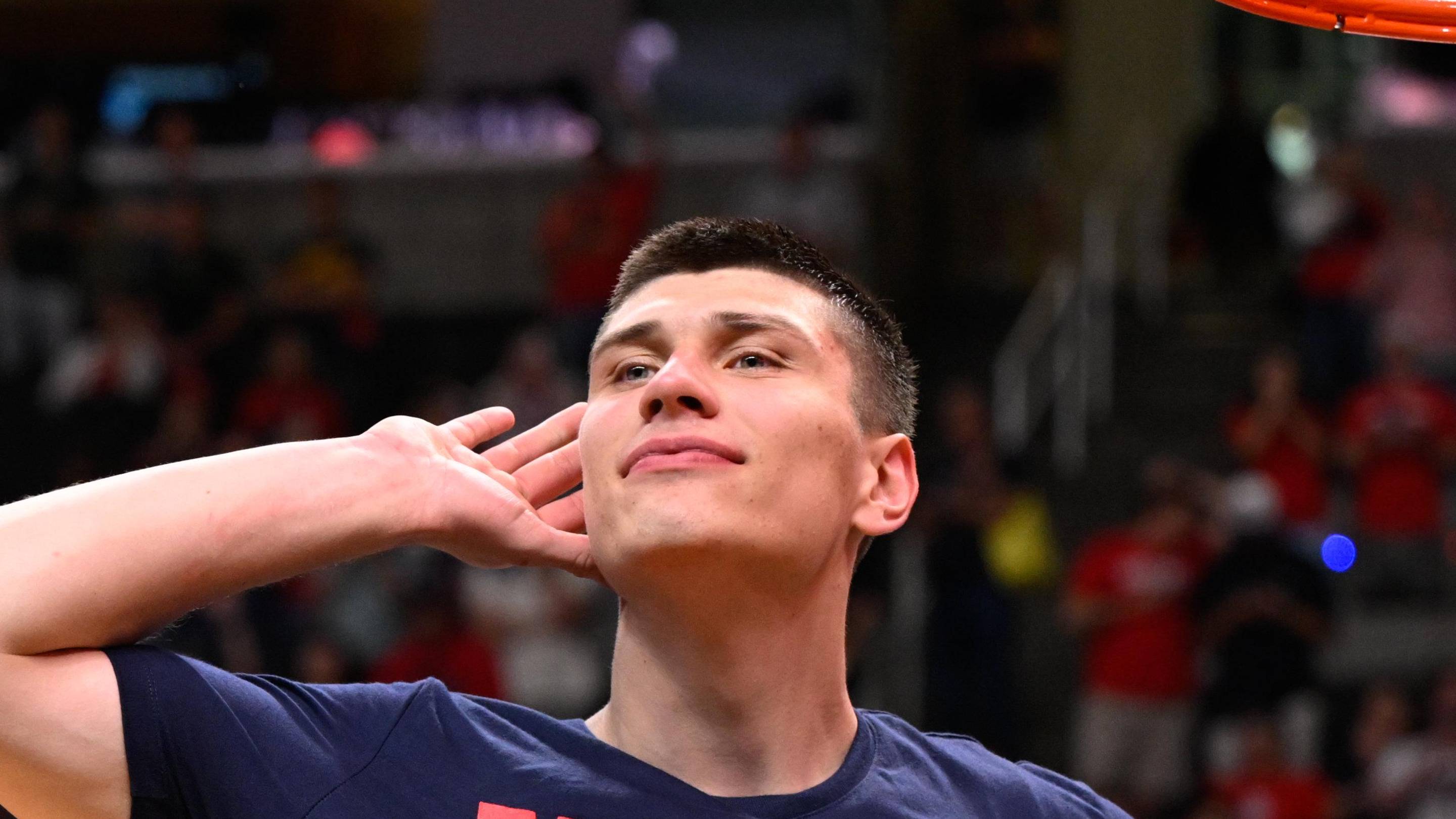 Mar 28, 2026; San Jose, CA, USA; Arizona Wildcats forward Ivan Kharchenkov (8) prepares to cut down the net after an Elite Eight game against the Purdue Boilermakers of the West Regional of the men's 2026 NCAA Tournament at SAP Center. Mandatory Credit: Eakin Howard-Imagn Images | Eakin Howard-Imagn