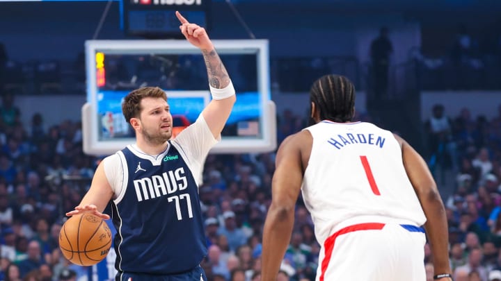 Apr 28, 2024; Dallas, Texas, USA;  Dallas Mavericks guard Luka Doncic (77) controls the ball as LA Clippers guard James Harden (1) defends during the first quarter during game four of the first round for the 2024 NBA playoffs at American Airlines Center. Mandatory Credit: Kevin Jairaj-USA TODAY Sports